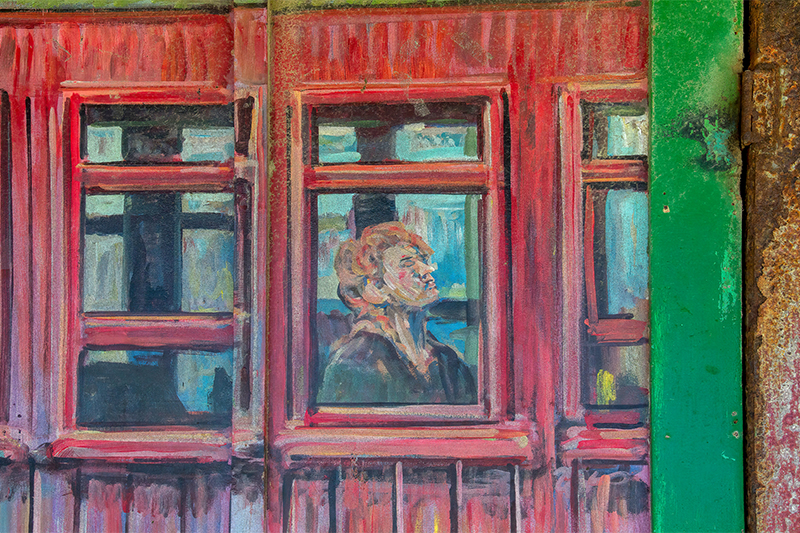 Mudge Mural Lady in Window 800x533